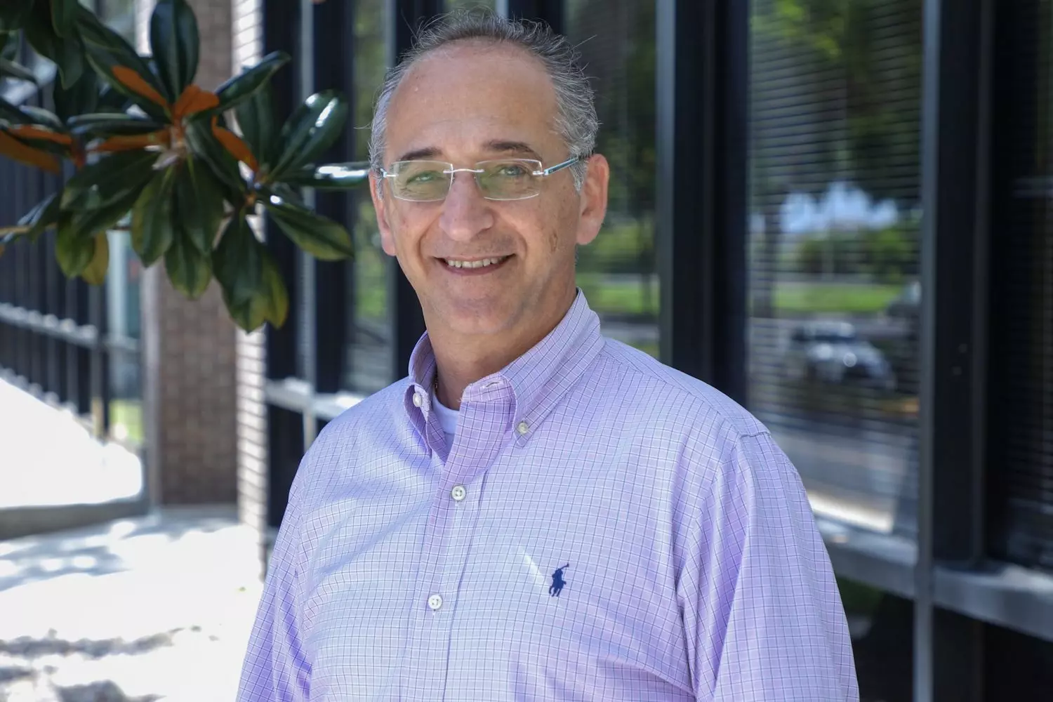 Nigel Spear — a leading obstetrician-gynecologist in Florida, photo outdoors Dr. Nigel Spear in casual clothing in front of a medical center in Florida