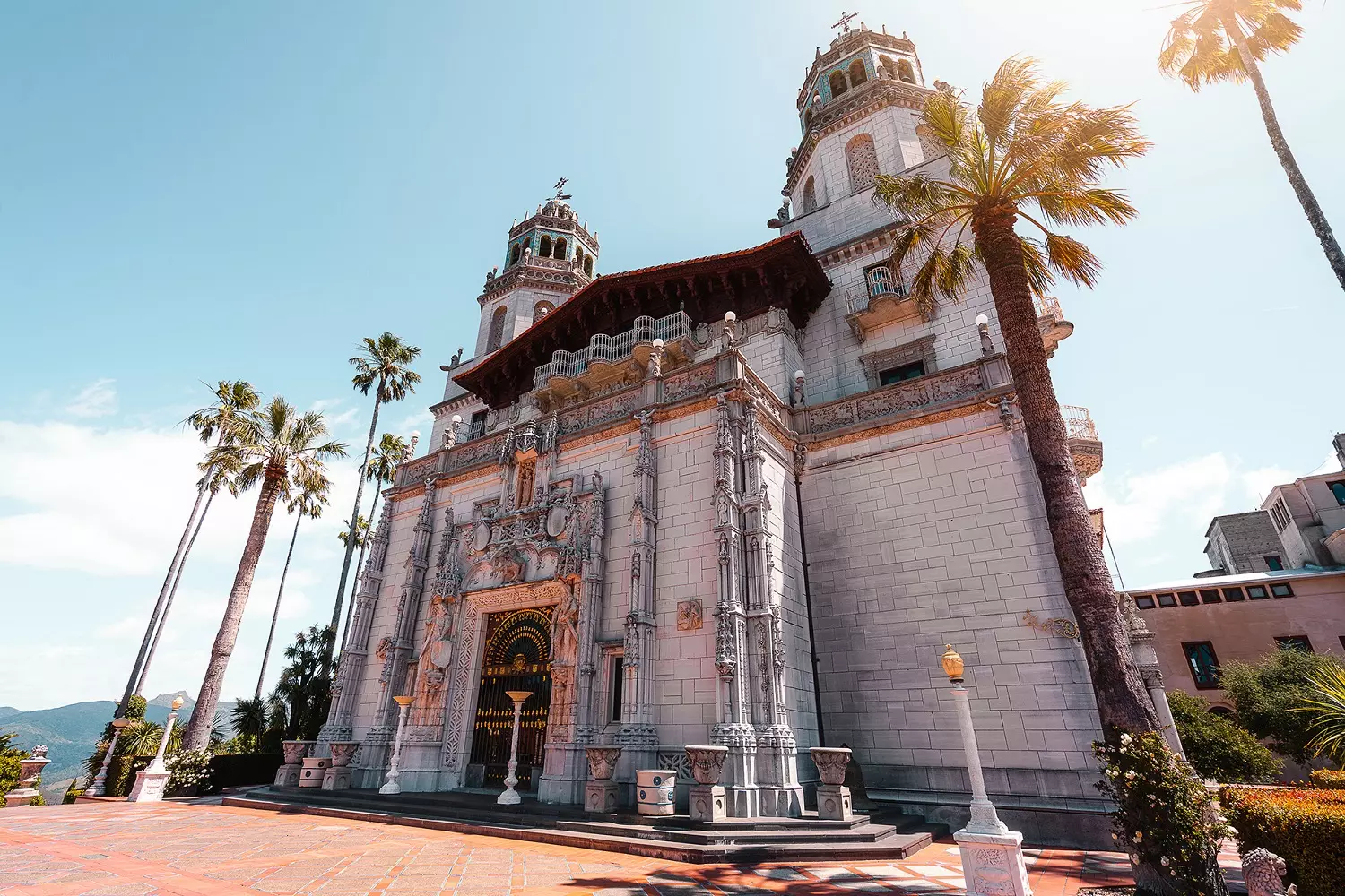 Main facade of Hearst Castle in California Majestic main facade of Hearst Castle surrounded by lush greenery