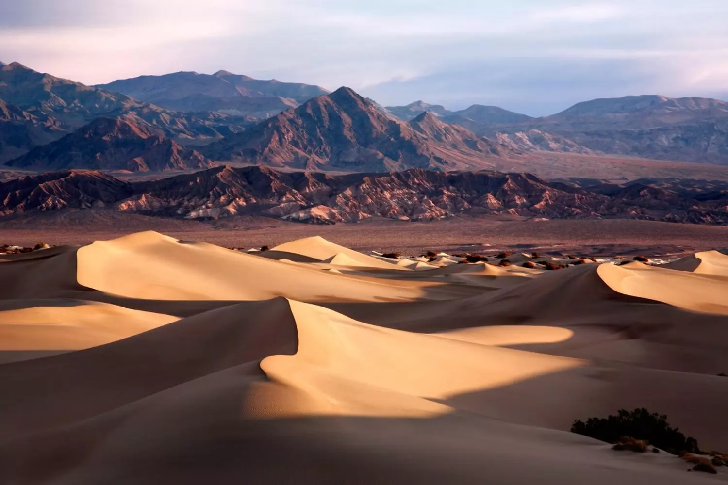 Death Valley — Alien Landscapes of Earth's Hottest Place | Photo Surreal landscapes of Death Valley: golden dunes, salt flats and mountains under scorching sun