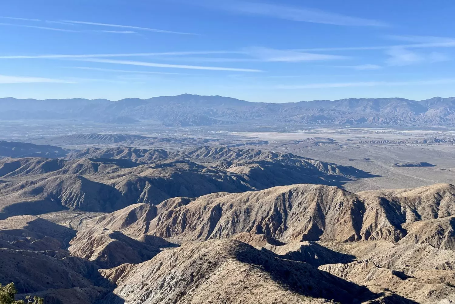 Breathtaking Panorama of Joshua Tree National Park from Above Aerial view of Joshua Tree National Park showcasing vast desert landscape with distinctive rock formations, scattered Joshua trees, and winding trails under dramatic cloud-filled skies