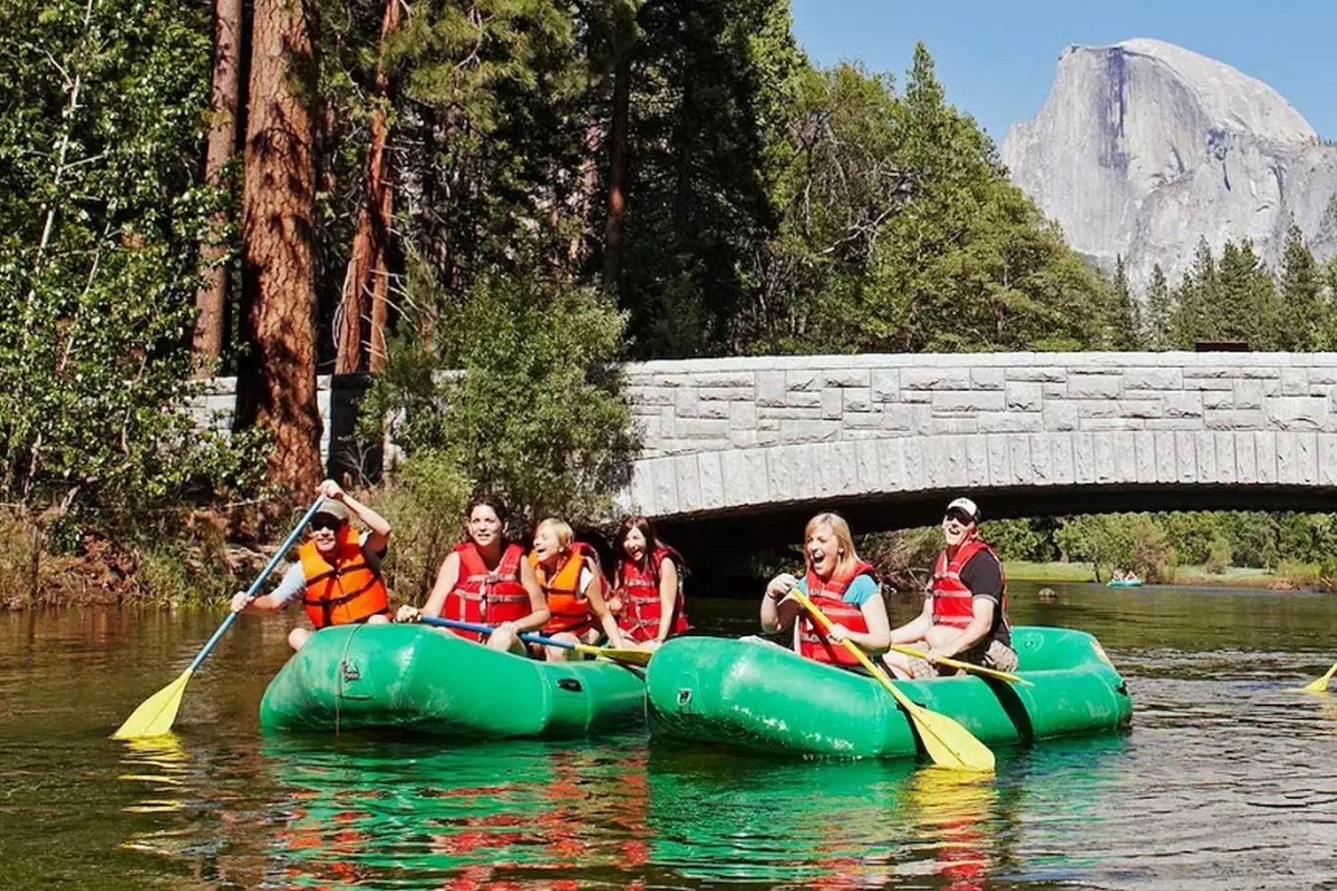 Paddling Through Paradise: Kayaking Adventure in Yosemite Kayaking on the crystal-clear waters of Yosemite National Park with towering granite cliffs and lush forests in the background