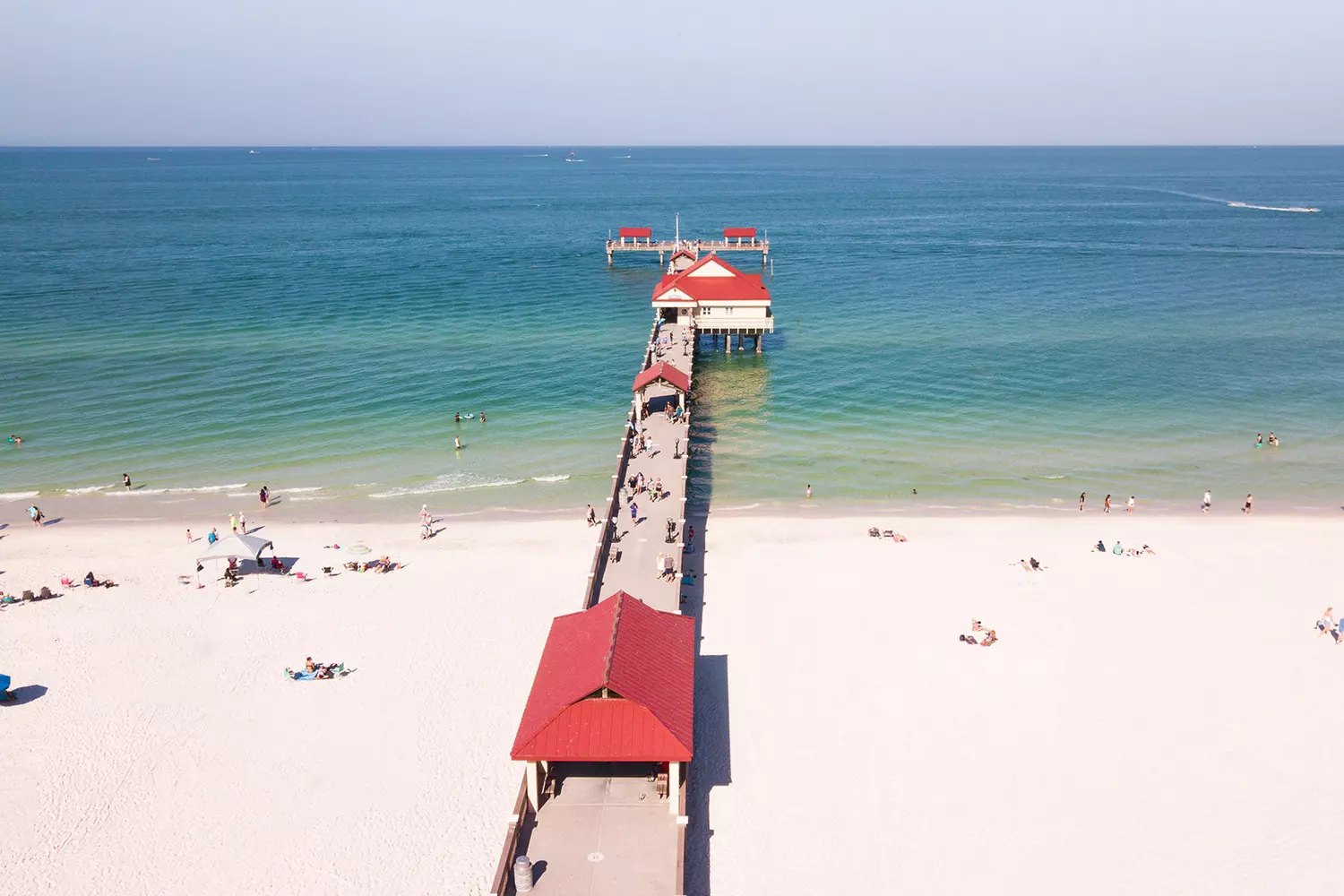 Clearwater Pier 60 — Sunset Celebrations & Ocean Views Iconic Pier 60 in Clearwater Beach stretching into the Gulf of Mexico with sunset sky and fishing poles visible