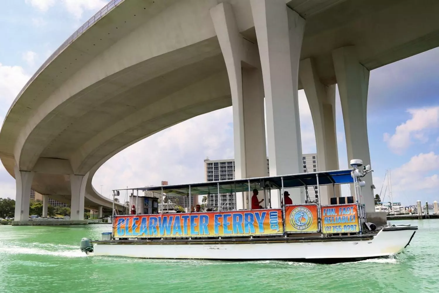 Clearwater Water Taxi — Fun & Scenic Boat Rides Along the Coast Colorful Clearwater water taxi cruising through calm blue waters with sunny sky and coastal views