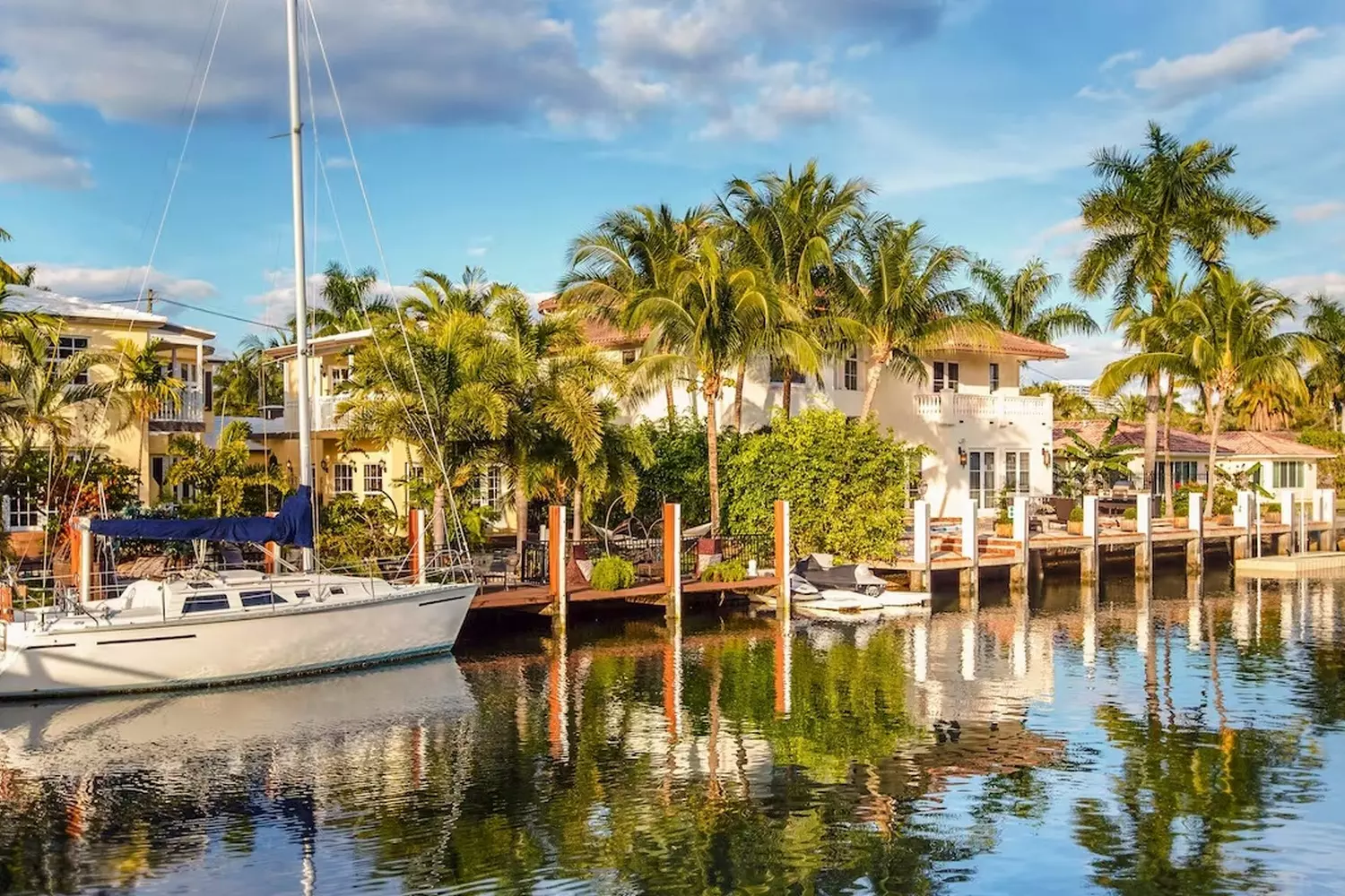 The "Venice of America" — Fort Lauderdale's Canals A picturesque Fort Lauderdale canal with a white yacht gliding through the turquoise water