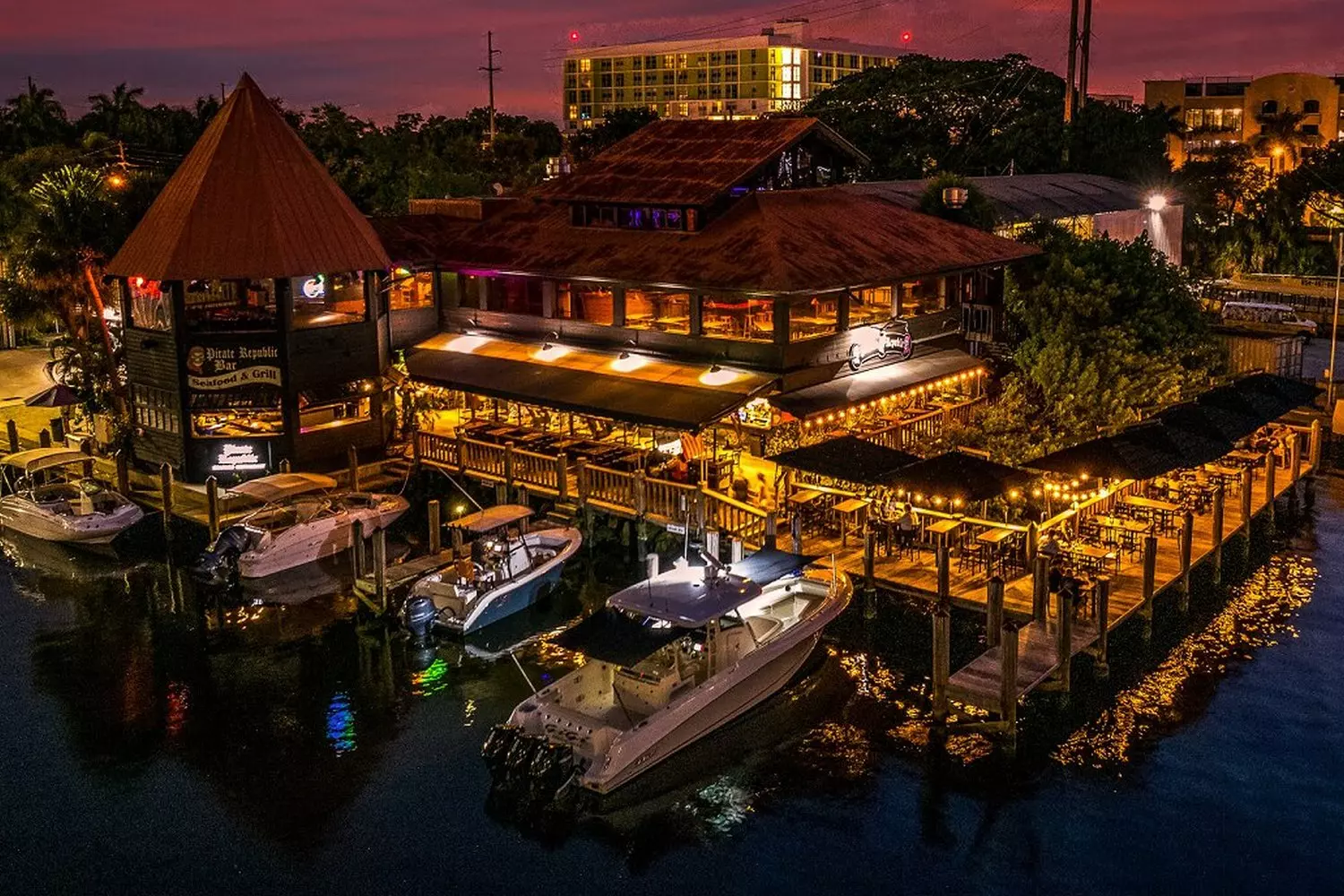 Nighttime Fort Lauderdale: sparkling waterfront and city lights Fort Lauderdale Nightscape: Illuminated yachts and luxury hotels reflect in the canals, while neon restaurant signs create colorful glows on the water beneath Florida's starry sky