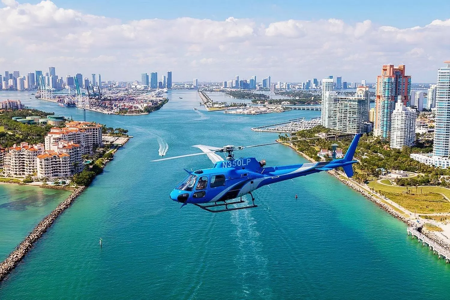 Helicopter Soaring Over South Miami Beach — Aerial View of the Coastline A helicopter flying over the sunny skies of South Beach with the ocean and cityscape in the background