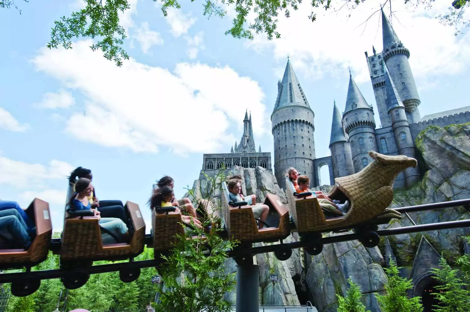 The "Flight of the Hippogriff" attraction at Islands of Adventure — soaring over Hogwarts Family roller coaster "Flight of the Hippogriff" in the Harry Potter world, with a view of Hagrid's hut and Hogwarts castle