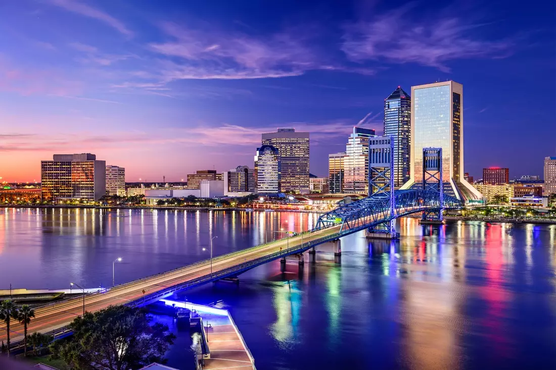 Stunning night skyline of Jacksonville, Florida — a vibrant city by the river Night view of downtown Jacksonville with illuminated buildings and city lights reflecting on the St. Johns River