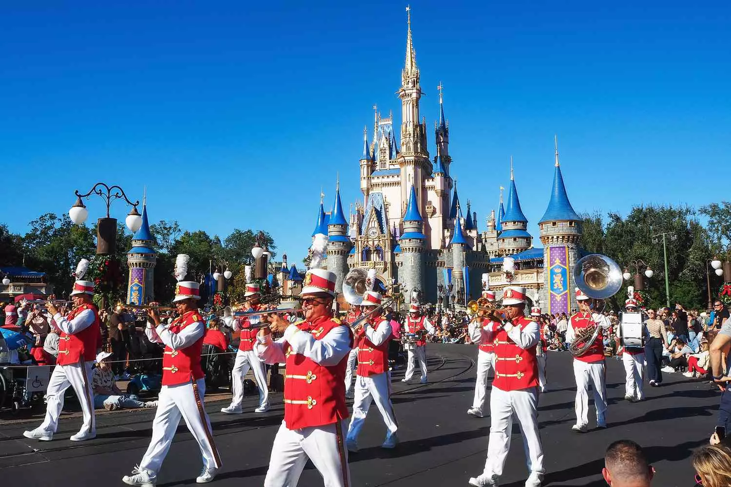 Morning Parade at Magic Kingdom Orlando: Disney Heroes, Floats, and Happy Spectators with Cinderella Castle in the Background Morning Parade at Magic Kingdom Orlando: Disney Heroes, Floats, and Happy Spectators with Cinderella Castle in the Background