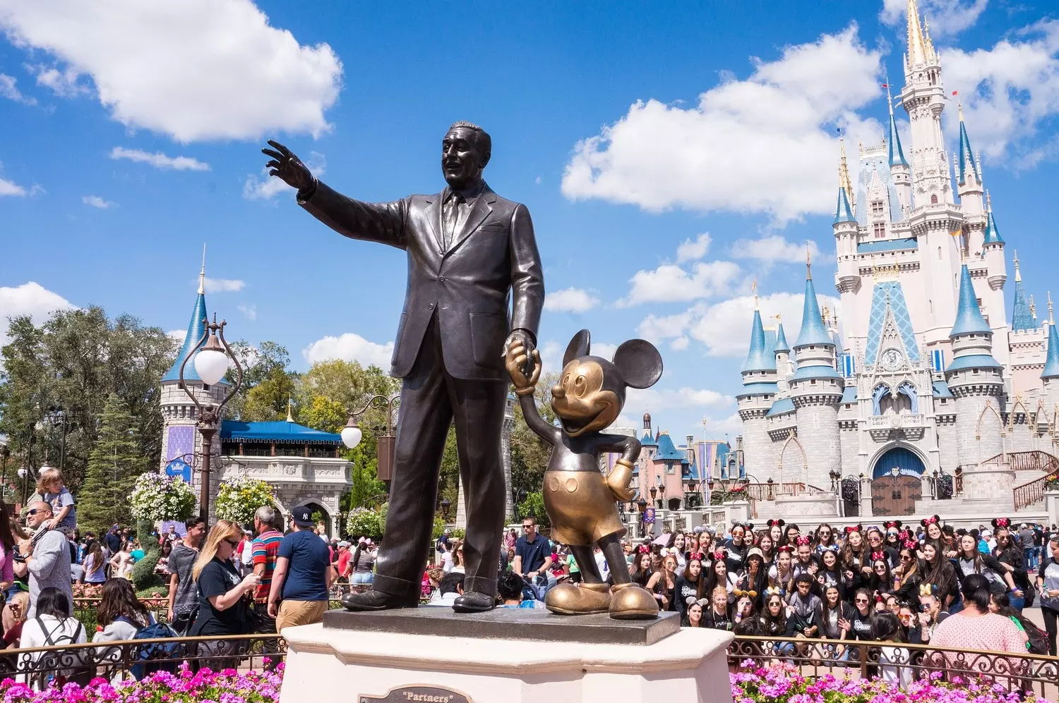 Disney Magic – Cinderella Castle and Mickey Mouse | Magic Kingdom Orlando Disney character performers waving near Cinderella Castle at Magic Kingdom, Orlando