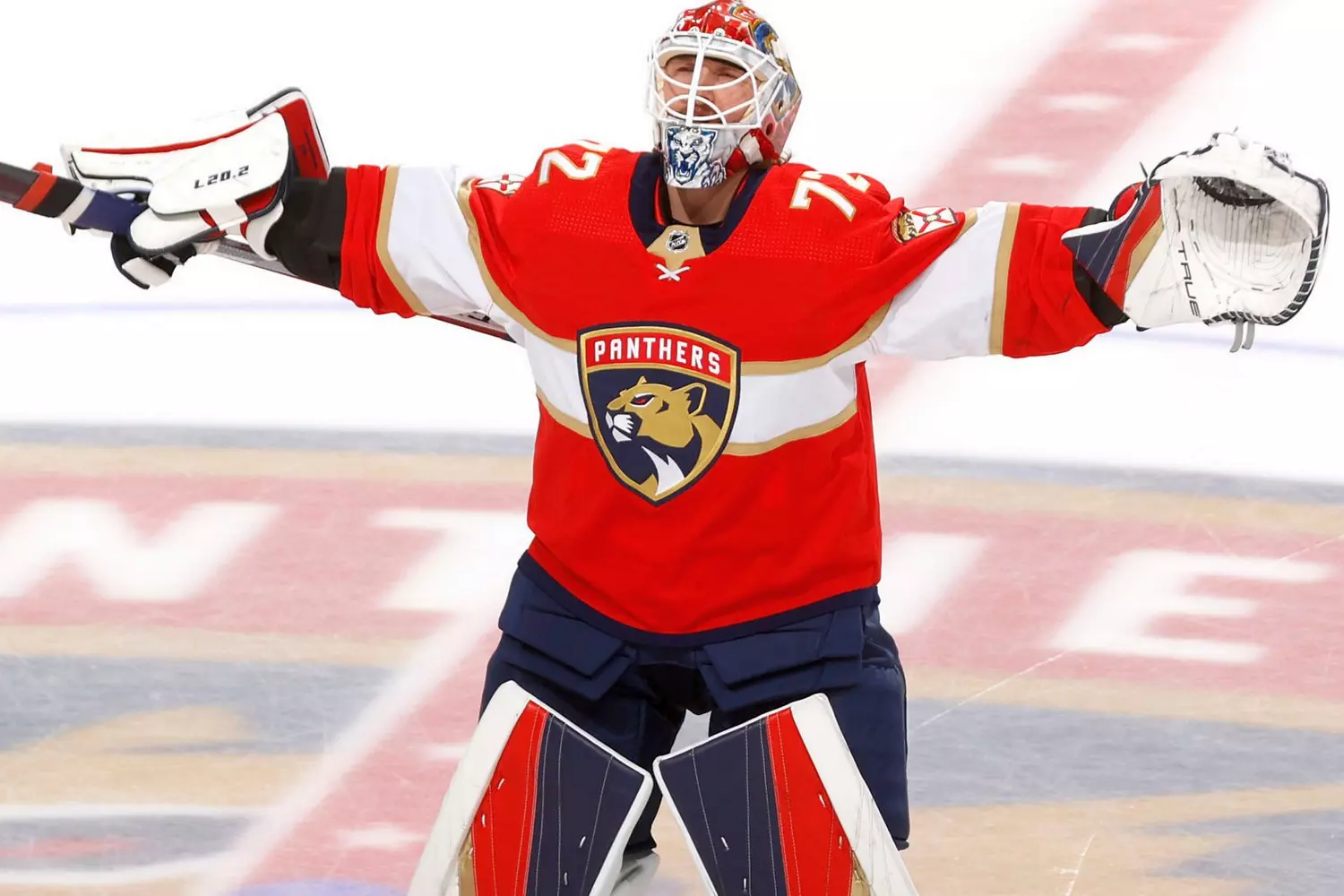 Florida Panthers: Sergei Bobrovsky celebrates victory on the ice Florida Panthers goalie Sergei Bobrovsky poses with his arms up in a joyful pose during a hockey game