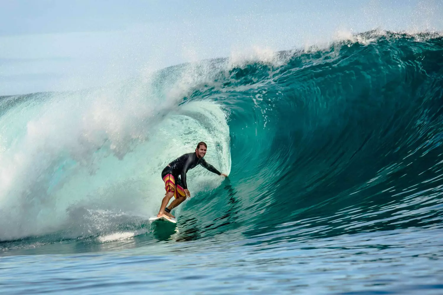 Thrilling Surf Adventure in Miami — Ride with Style Athlete surfing on a board amid waves near Miami coastline