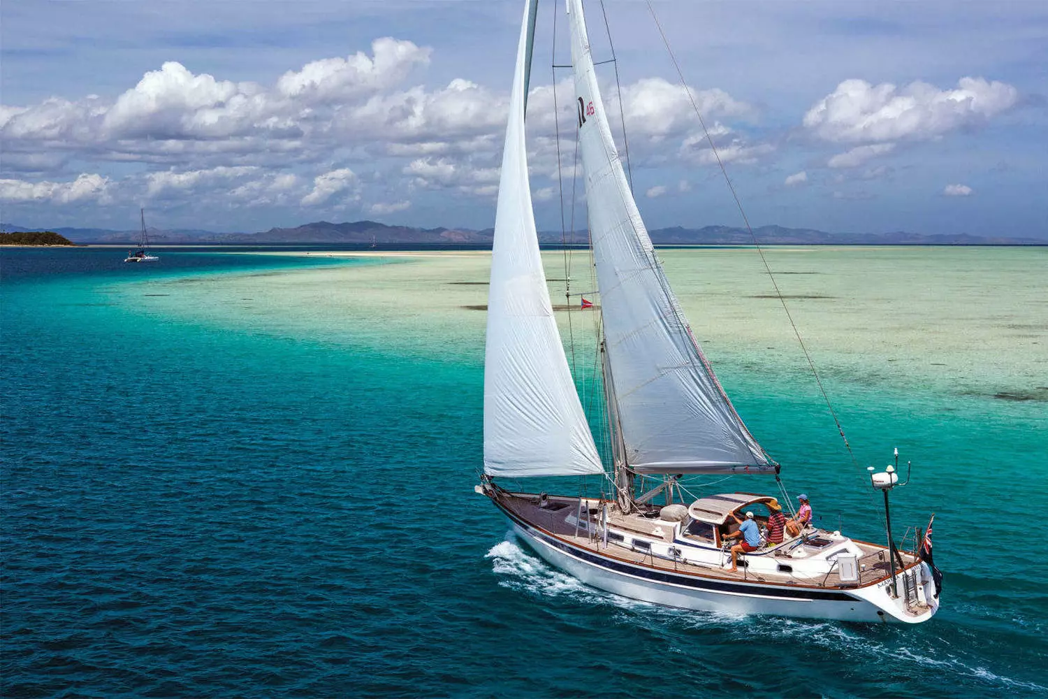 Miami Yacht Charter — Luxury Sailing Experience White sailboat gliding through turquoise waters of Miami Bay