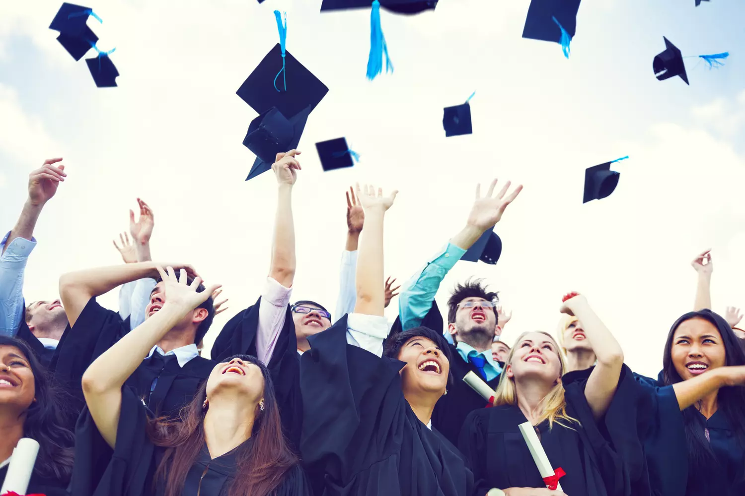 Success Stories: Alumni of Top American Private Schools Graduating students in caps and gowns celebrating with diplomas at a U.S. private school ceremony, confetti in the air