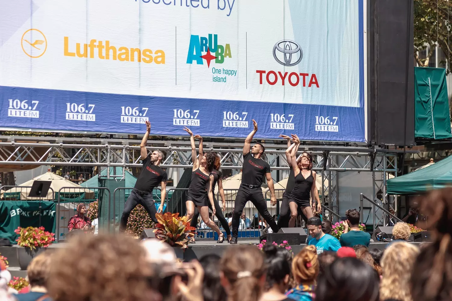 Performers are performing in Bryant Park Musical performers on the Broadway in Bryant Park stage