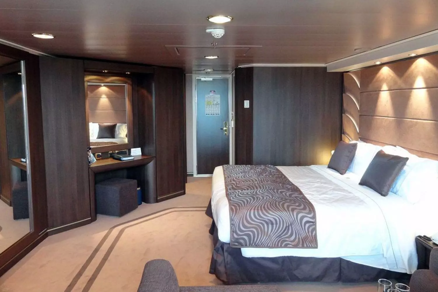 MSC Divina Stateroom — Luxury Cruise Cabin Experience Elegant cabin on MSC Divina cruise ship with comfortable bed and modern decor