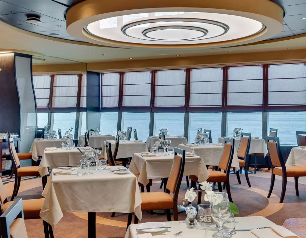 Fine Dining on MSC Meraviglia — A Culinary Journey at Sea Elegant restaurant aboard MSC Meraviglia cruise ship with stylish decor, ambient lighting, and attentive waitstaff serving gourmet dishes