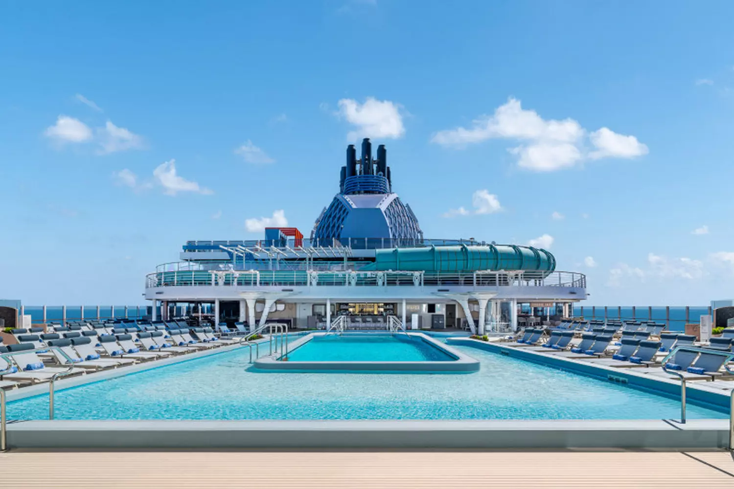 Norwegian Aqua — Stunning Pool Deck with Panoramic Ocean Views Vibrant pool deck on Norwegian Aqua cruise ship with sun loungers, tropical cocktails, and ocean views under sunny skies