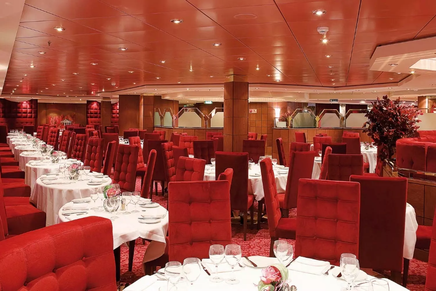 MSC Poesia Restaurant — Fine Dining Experience at Sea Elegant dining room aboard MSC Poesia cruise ship with stylish decor, white linen tables, and ocean views