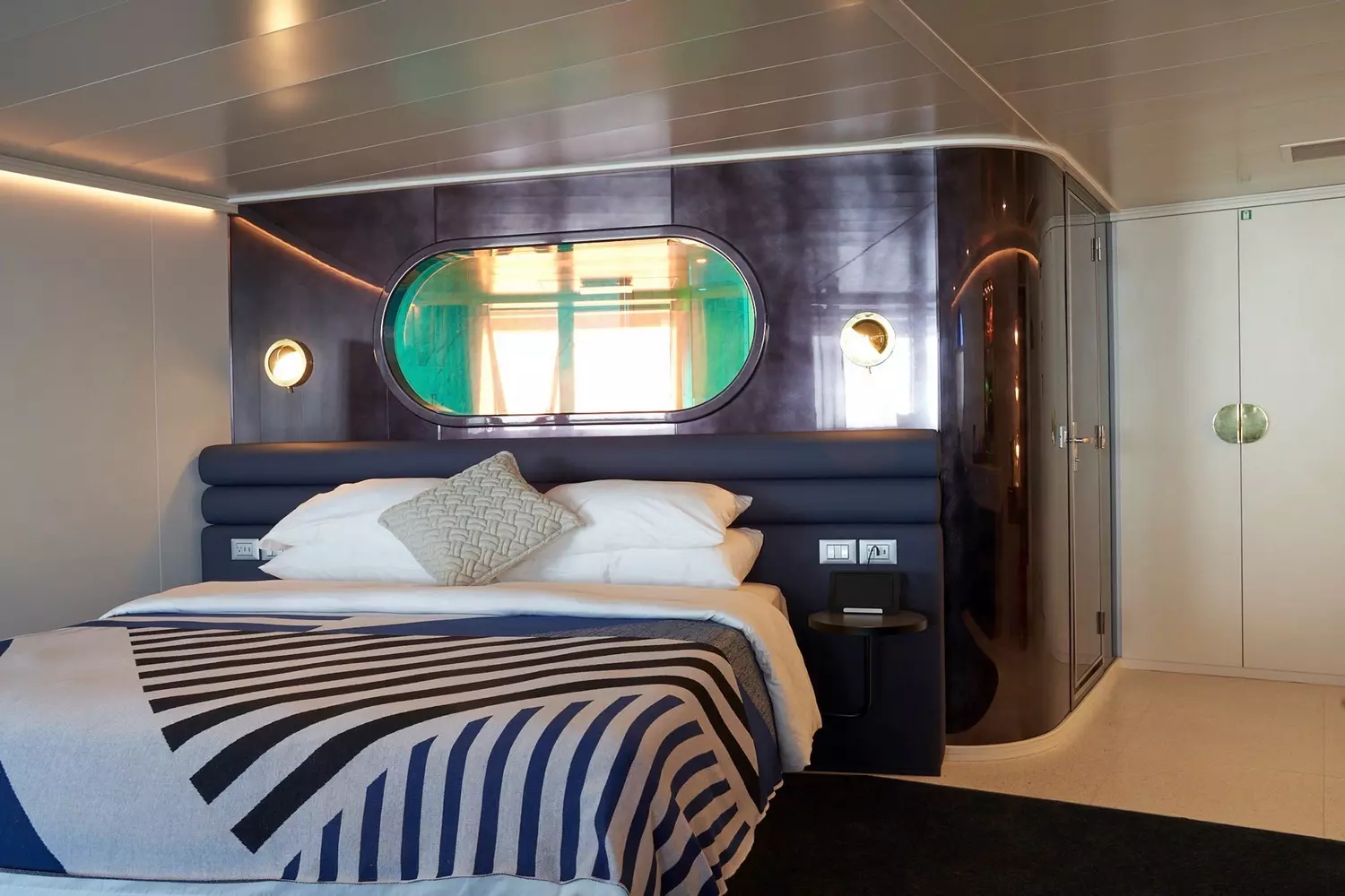Scarlet Lady's Stylish Cabin Retreat - Boutique Hotel Luxury at Sea Modern luxury cabin aboard Scarlet Lady cruise ship featuring a plush queen bed, sleek minimalist design, mood lighting, and ocean-view balcony