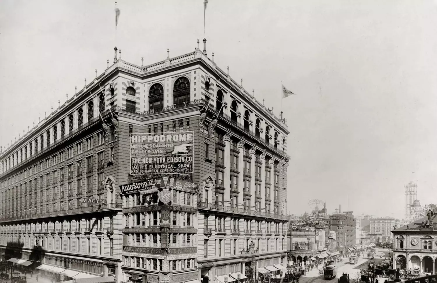 Step Back in Time: Vintage Photo of Macy's Department Store in Its Golden Era Black and white historical photograph of Macy's iconic department store exterior with classic signage, bustling crowds, and vintage cars parked outside