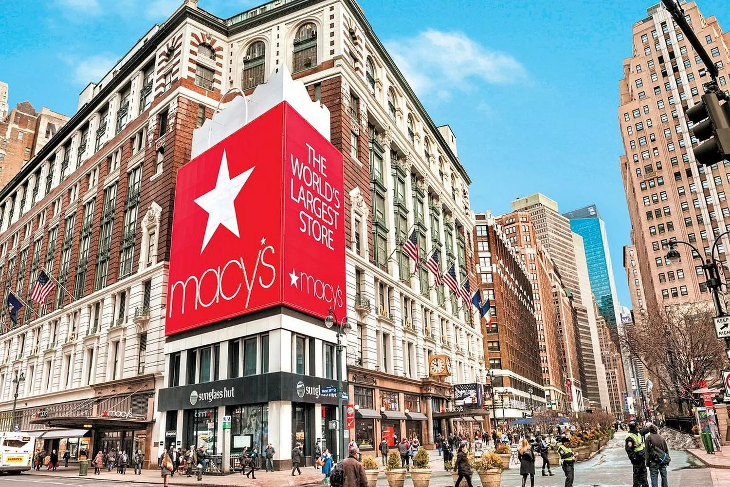 Macy's Herald Square: The Heartbeat of American Retail Vibrant interior of Macy's flagship Herald Square store with multiple escalators, colorful displays, and shoppers exploring America's largest department store during holiday season decorations