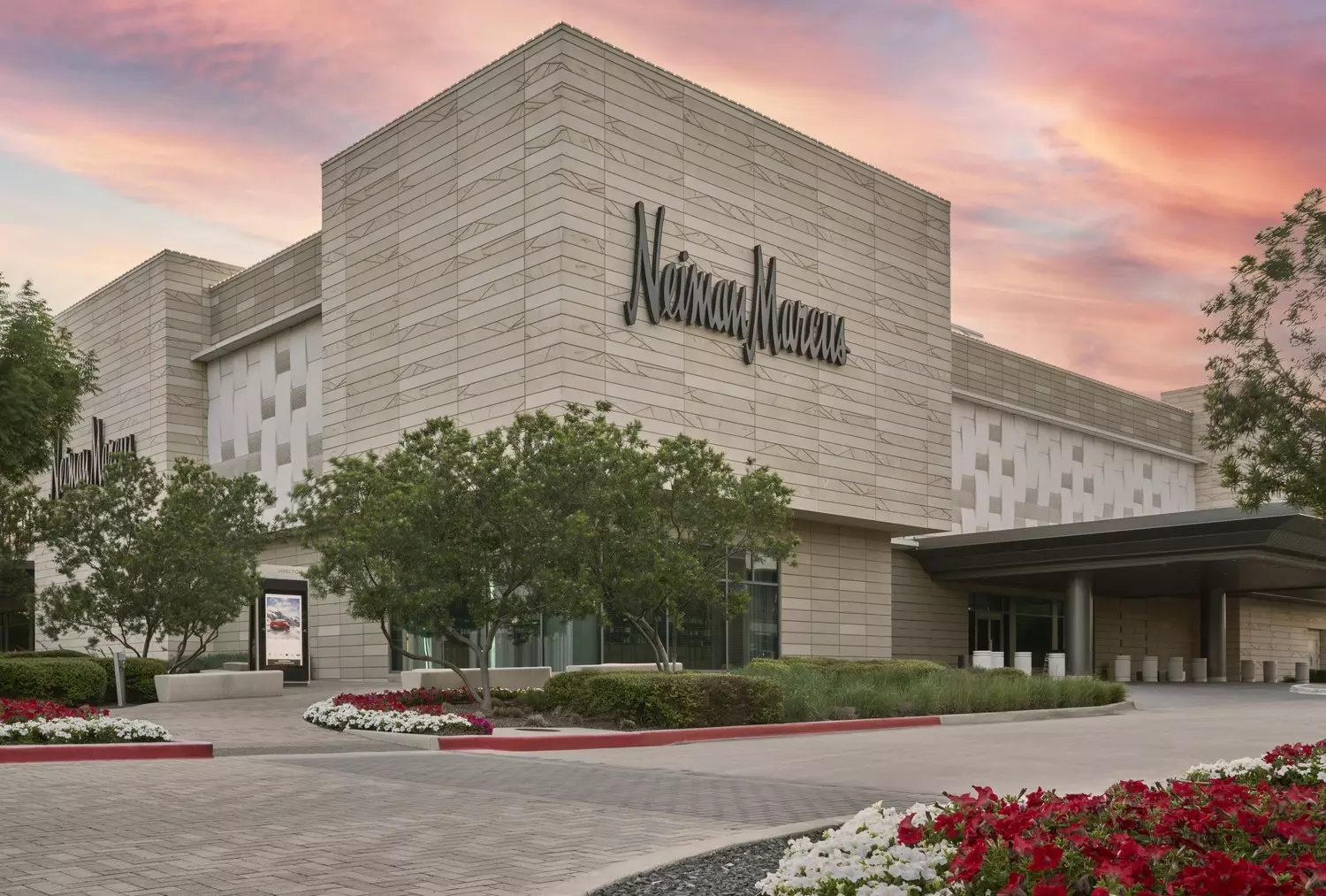 Neiman Marcus: Where Luxury Lives Elegant interior of Neiman Marcus department store showcasing high-end fashion displays, marble floors, and sophisticated shoppers browsing luxury designer collections in a refined retail setting