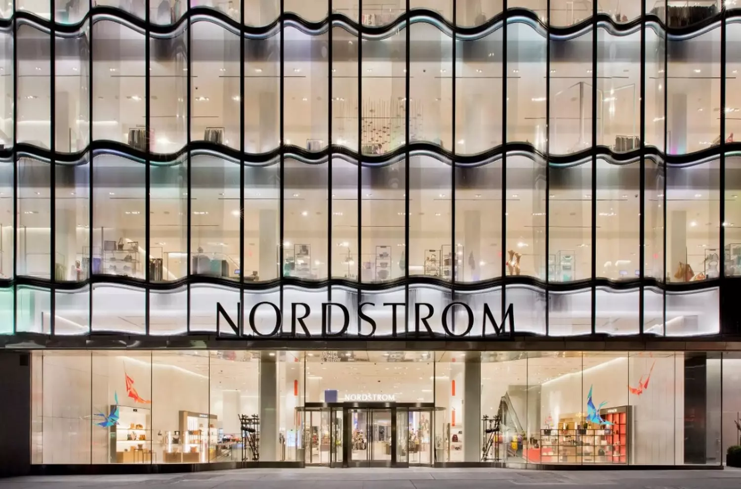 Nordstrom: Where Luxury Shopping Meets Unmatched Service Elegant multi-level Nordstrom department store interior with modern lighting, designer displays and attentive staff assisting shoppers in a premium retail environment