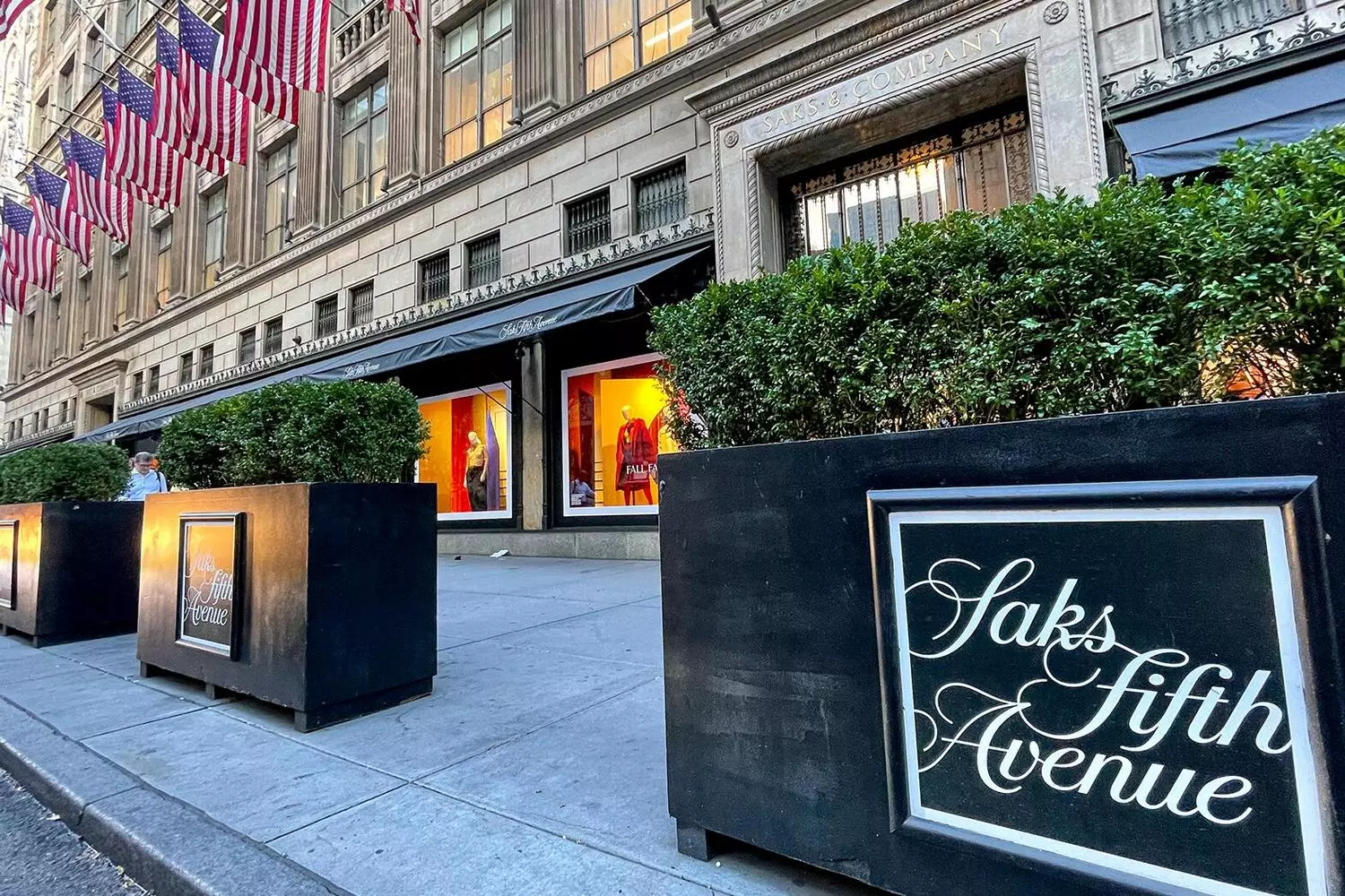 Saks Fifth Avenue: The Epitome of Luxury Shopping in New York Opulent interior of Saks Fifth Avenue's flagship store featuring designer boutiques, sparkling chandeliers, and elegant shoppers browsing luxury fashion displays along the iconic Fifth Avenue location