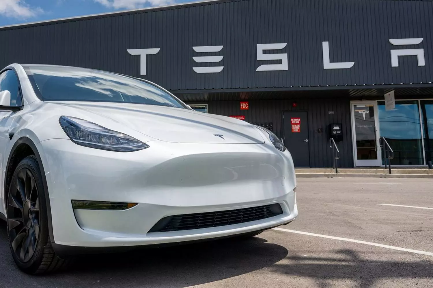 Tesla Car at a Tesla Store — Premium EV in Branded Showroom Tesla electric car in front of a Tesla store