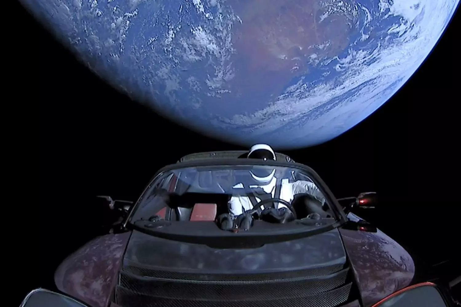 Tesla in Space — Elon Musk’s Roadster Starman Adventure Tesla car floating in outer space