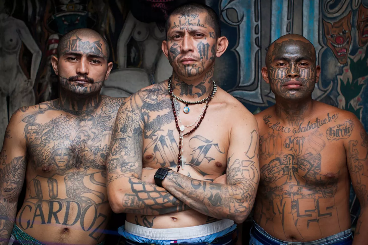 Kings of the Streets: The Unwritten Laws of the American Underground Members of a street gang in the USA stand together, flashing hand signs and wearing their gang’s colors
