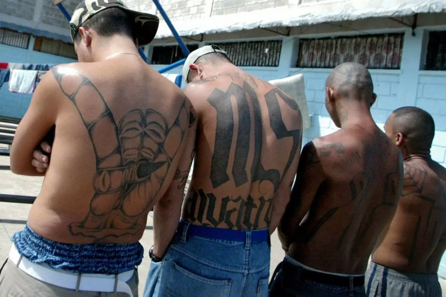 Kings of the Streets: The Unwritten Laws of the American Underground Members of a street gang in the USA stand together, displaying hand signs and wearing their gang’s colors