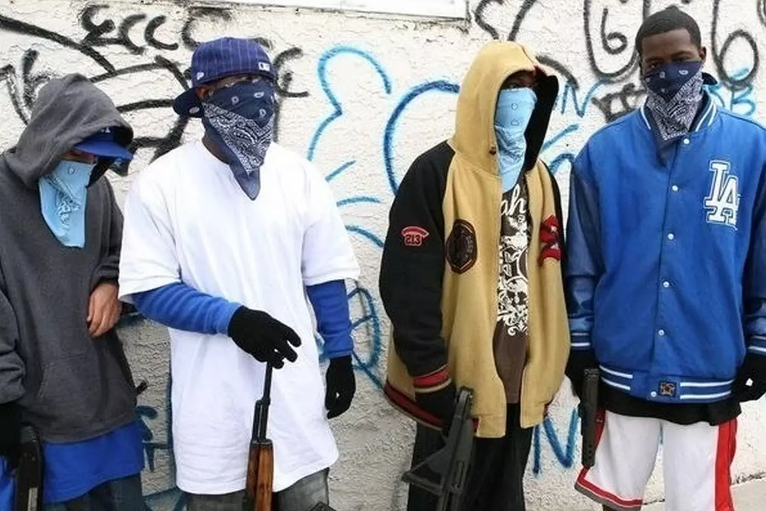 Blue Dominance: Crips Gang Members Show Their Loyalty on the Streets of the USA Members of the Crips street gang gathered together, displaying hand signs and wearing blue bandanas — their distinctive symbol