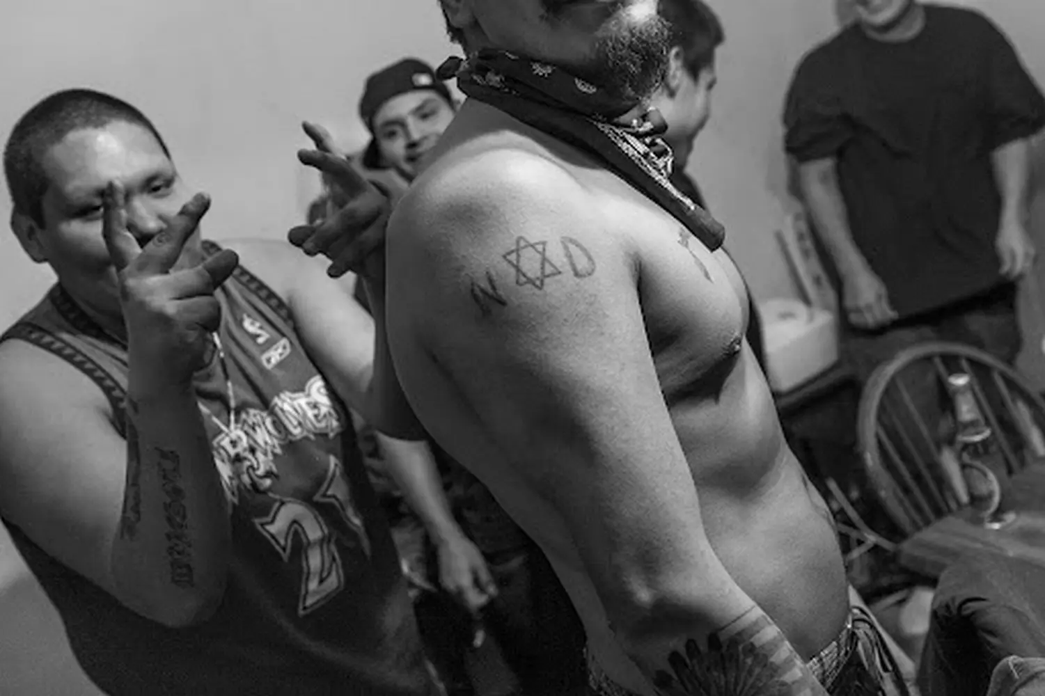 Six-Pointed Star: Gangster Disciples Mark Their Territory Members of the Gangster Disciples gang gathered in a Chicago neighborhood, displaying the distinctive six-pointed star hand signs