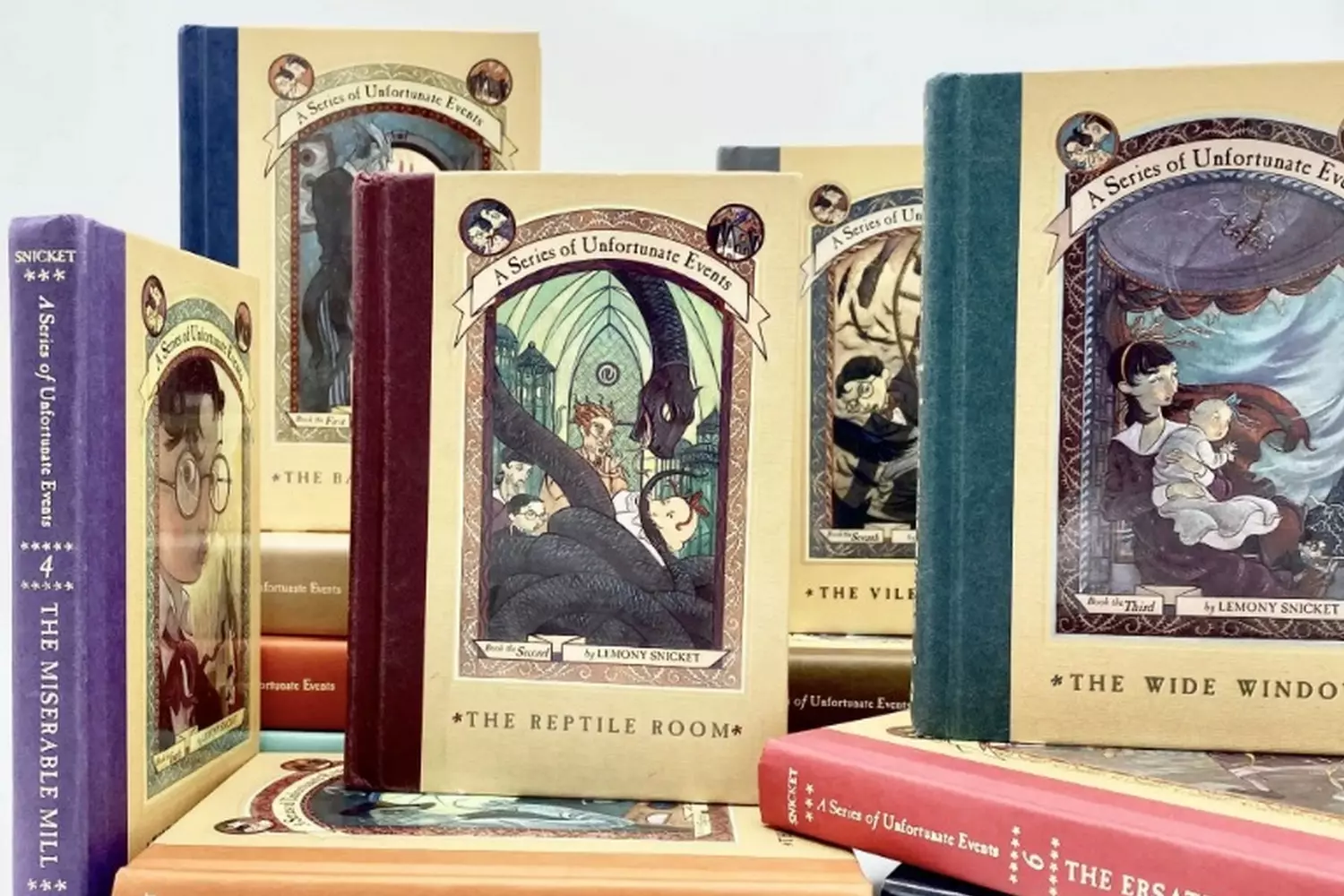 Darkly whimsical tales from Lemony Snicket's famous series for curious young readers Books from Lemony Snicket’s “A Series of Unfortunate Events” lined up on a shelf