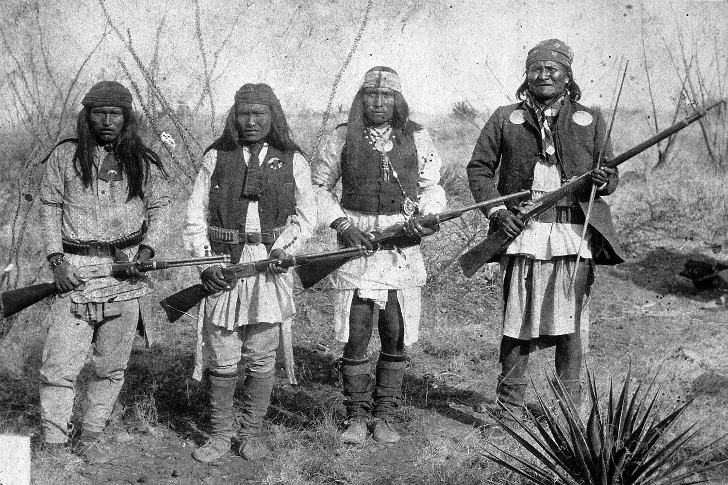 Apaches — warriors of the Southwest Group of Apaches in traditional clothing with weapons