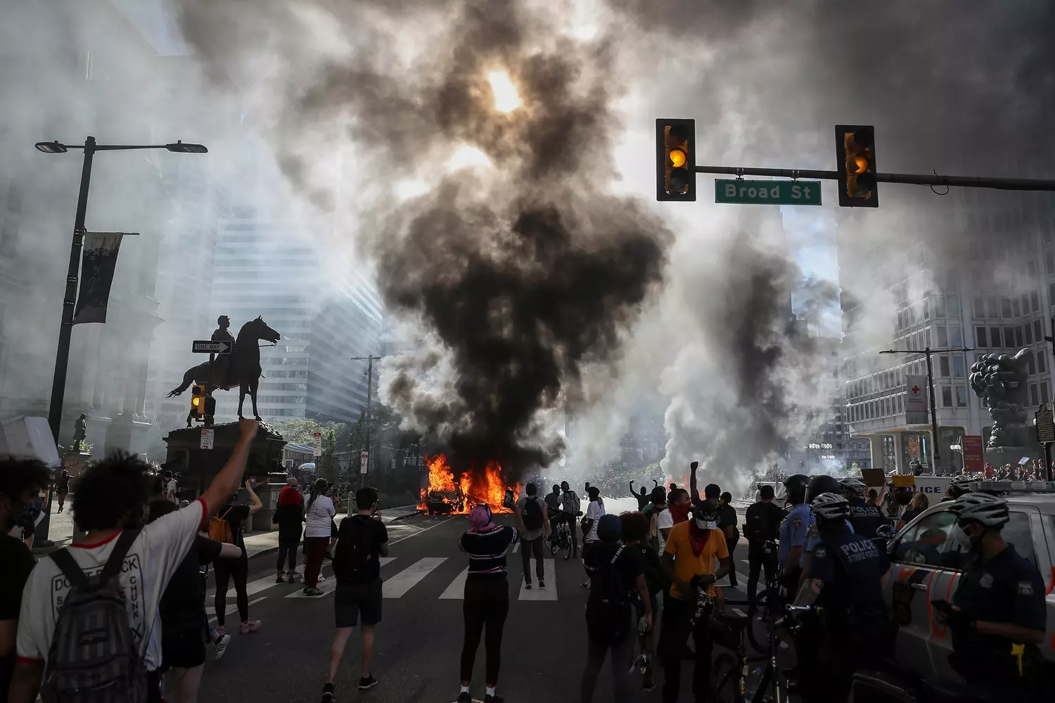 BLM Protests: Moments of Turmoil and Calls for Change A crowd of Black Lives Matter protesters during a demonstration, with signs, smoke, and police presence, reflecting tensions in the fight for racial justice