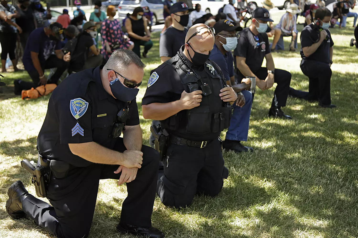 Controversial Gesture: Police Taking a Knee During BLM Protests Group of police officers kneeling during a Black Lives Matter demonstration, symbolizing both solidarity and controversy in the movement for racial justice