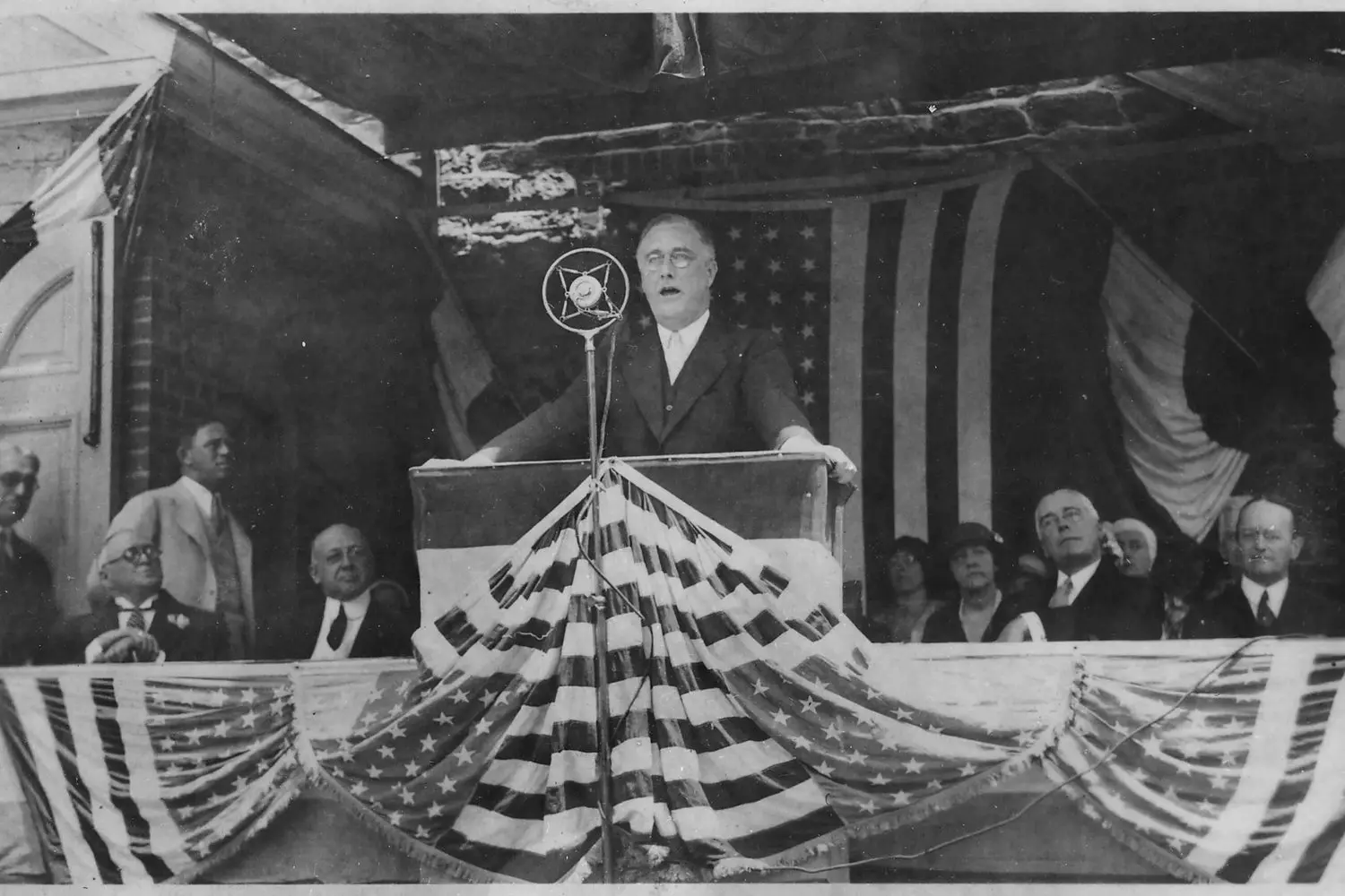 FDR’s Fireside Chat: Defining Moment of the New Deal Era President Franklin D. Roosevelt delivering a speech from a podium during the Great Depression era