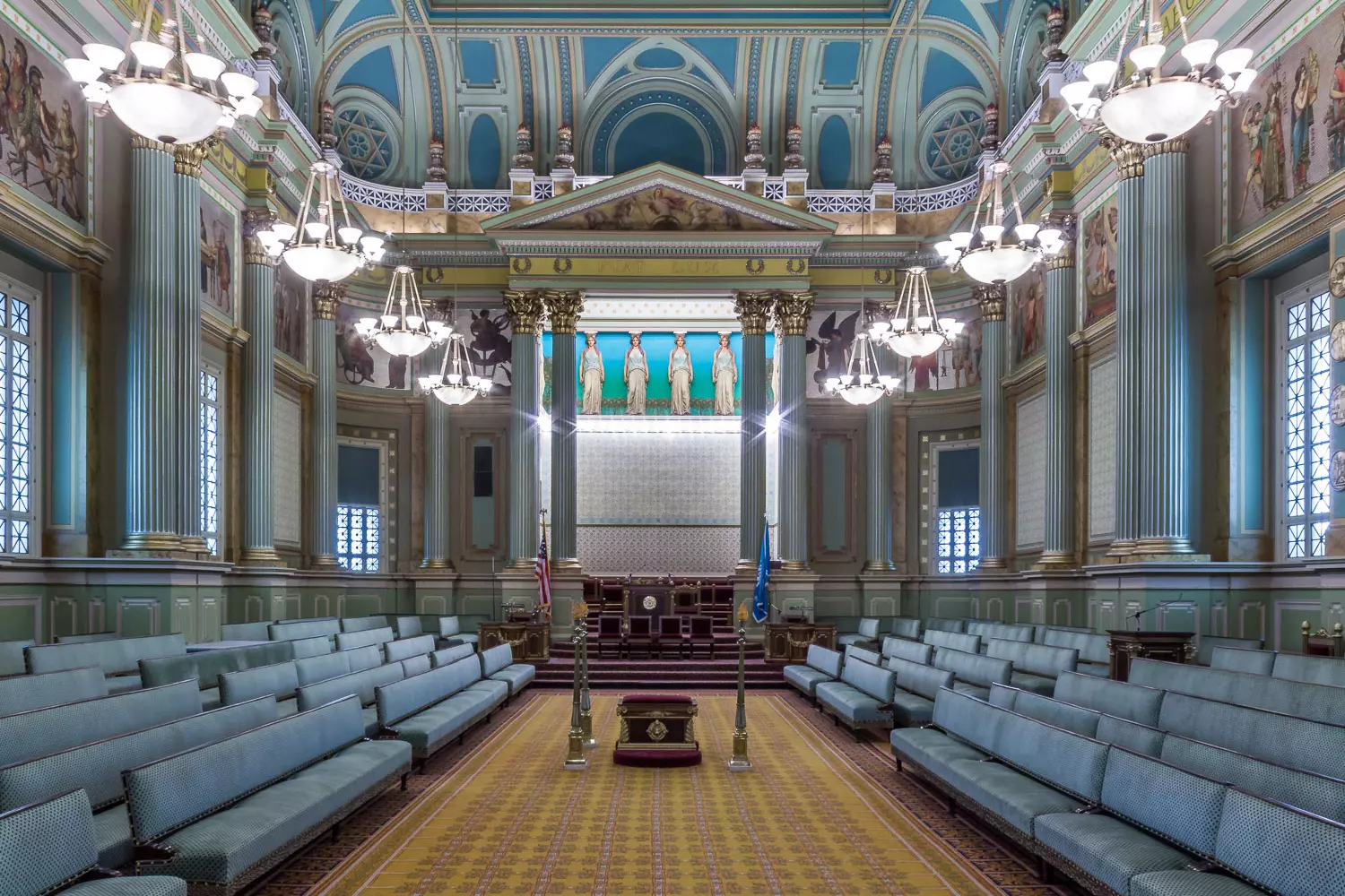 Majestic hall of the Masonic lodge | American Butler Interior of a Masonic lodge with symbols on the walls