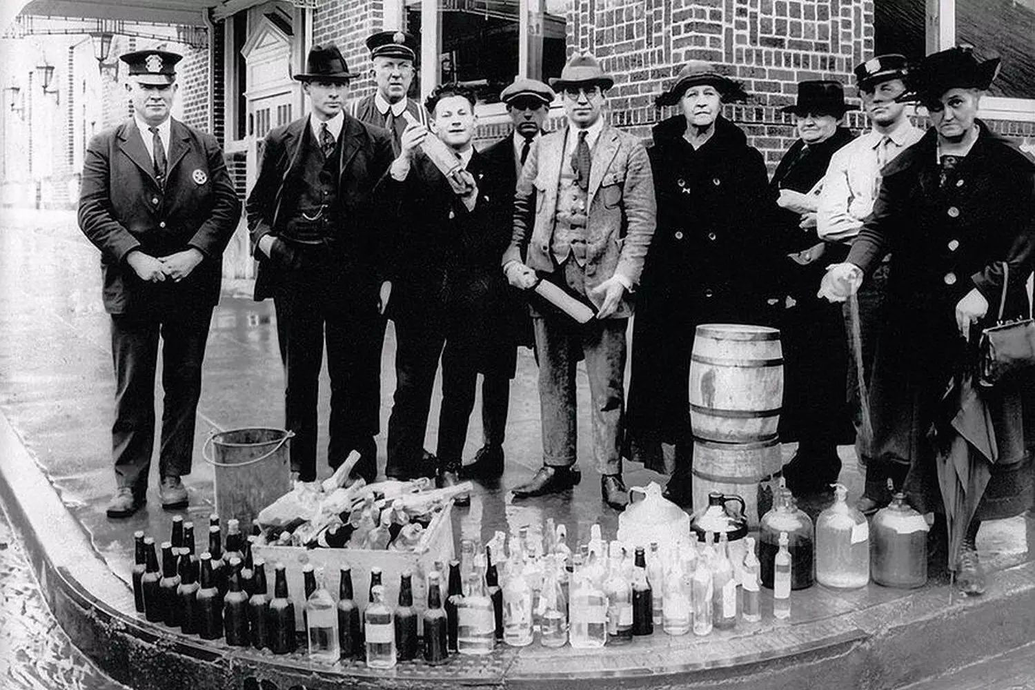 Prohibition Enforcement: Cops and Destroyed Liquor in the Roaring Twenties Police officers displaying confiscated liquor bottles during Prohibition in the US, 1920s