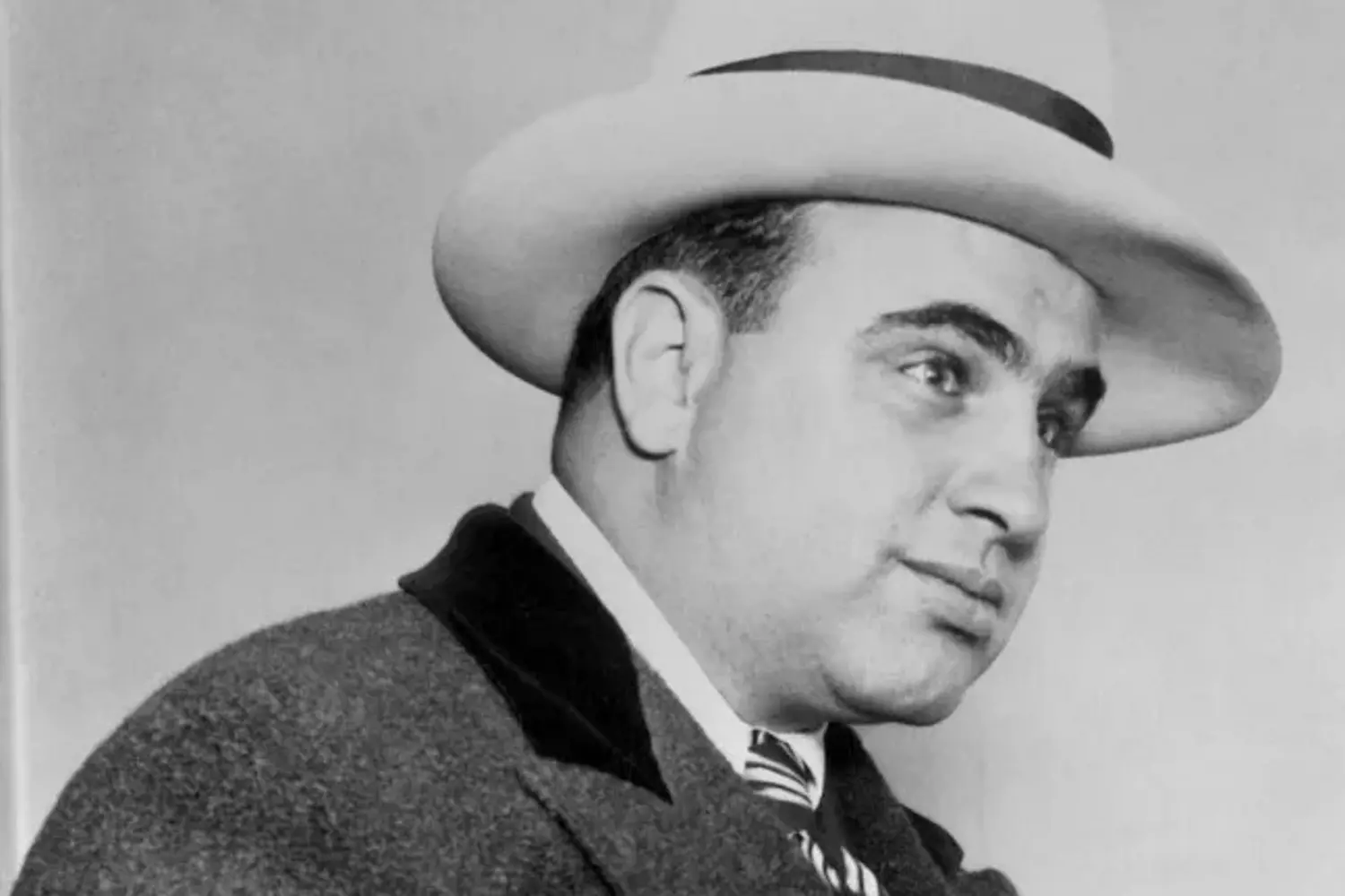 Al Capone: The Kingpin of American Organized Crime Al Capone, the most infamous gangster of the Prohibition era, wearing a suit and hat