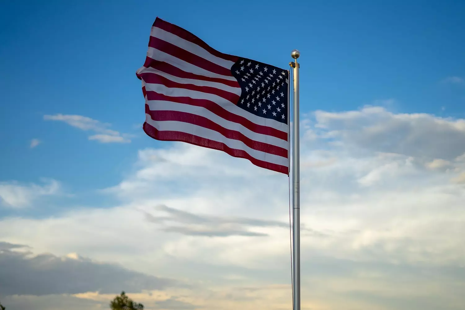 American flag against a sky background American flag against a sky background