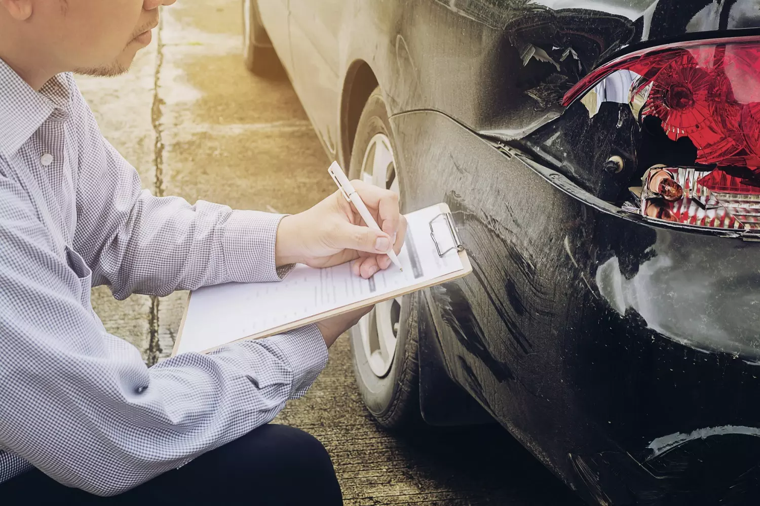 Parties involved in a car accident are documenting vehicle damage Parties involved in a car accident are documenting vehicle damage