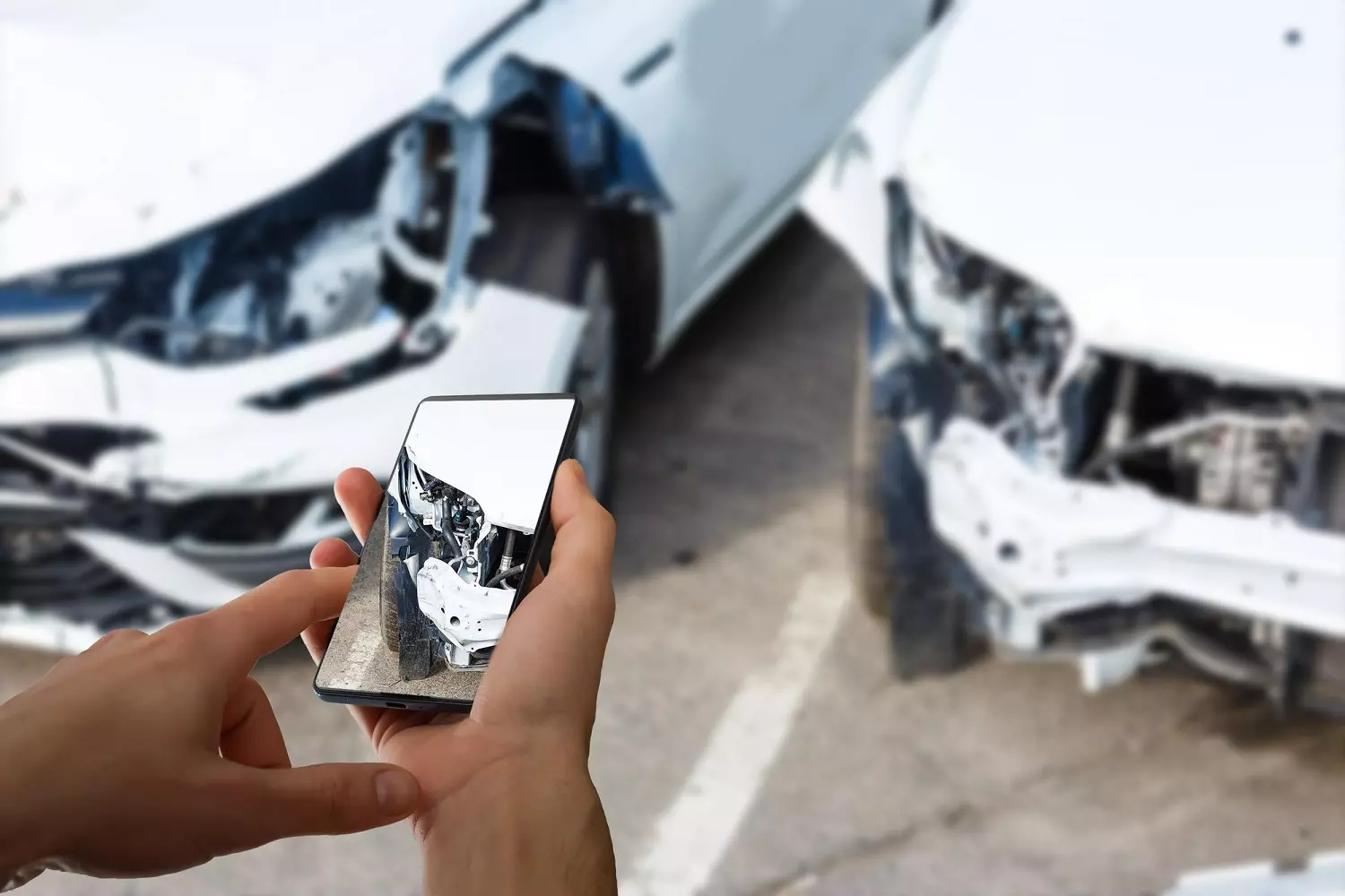 Photographing car damage for the insurance company A driver is photographing vehicle damage after an accident