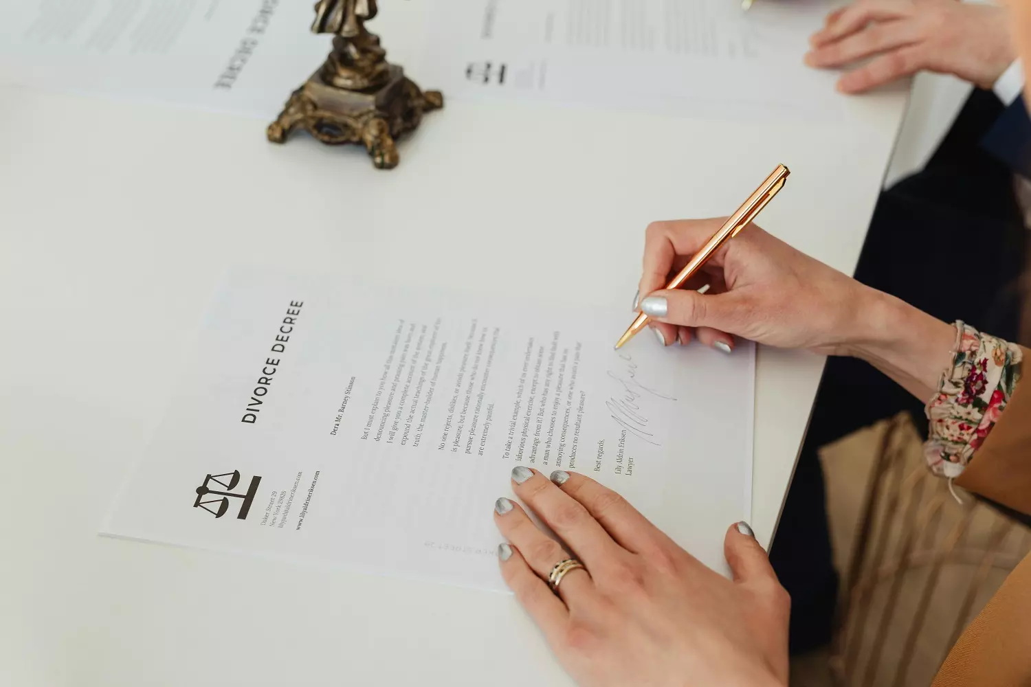 Spouses signing divorce papers Spouses signing divorce papers