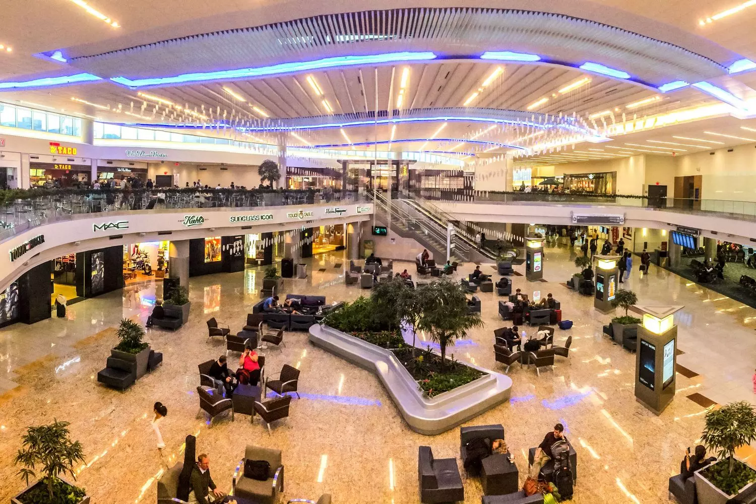 Atlanta Airport (ATL) — comfortable waiting areas and passenger amenities Interior of Atlanta International Airport with waiting areas, shops, and restaurants