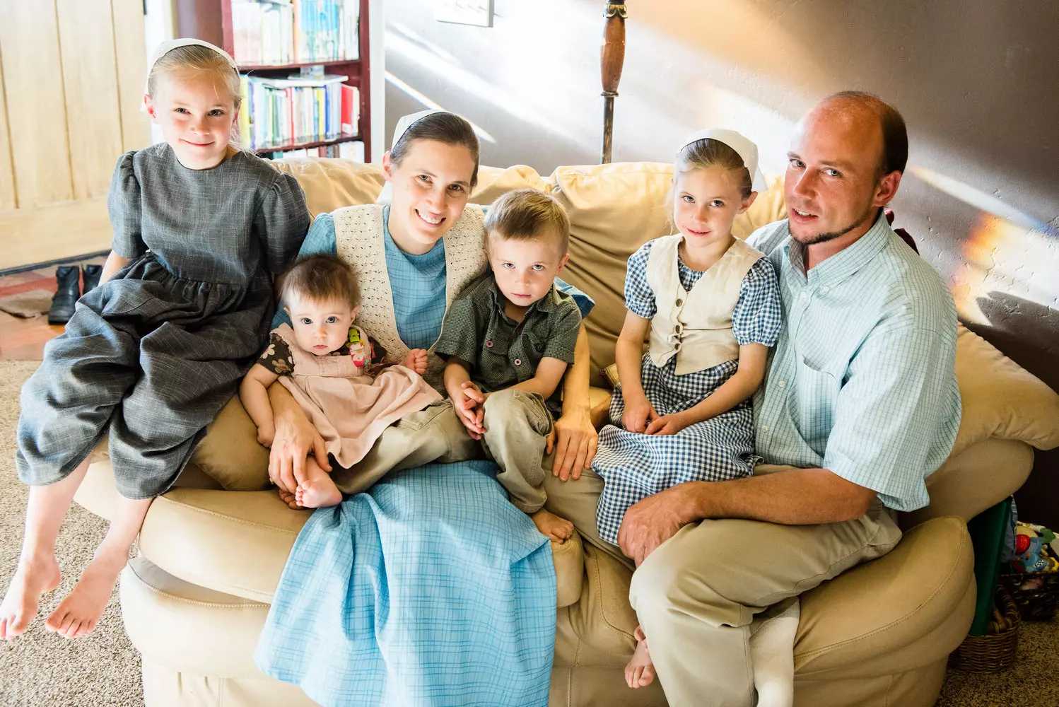 A Mennonite Family: Faith, Tradition, and Simple Living Mennonite family in traditional clothing: men in suspenders and shirts, women in modest dresses and bonnets