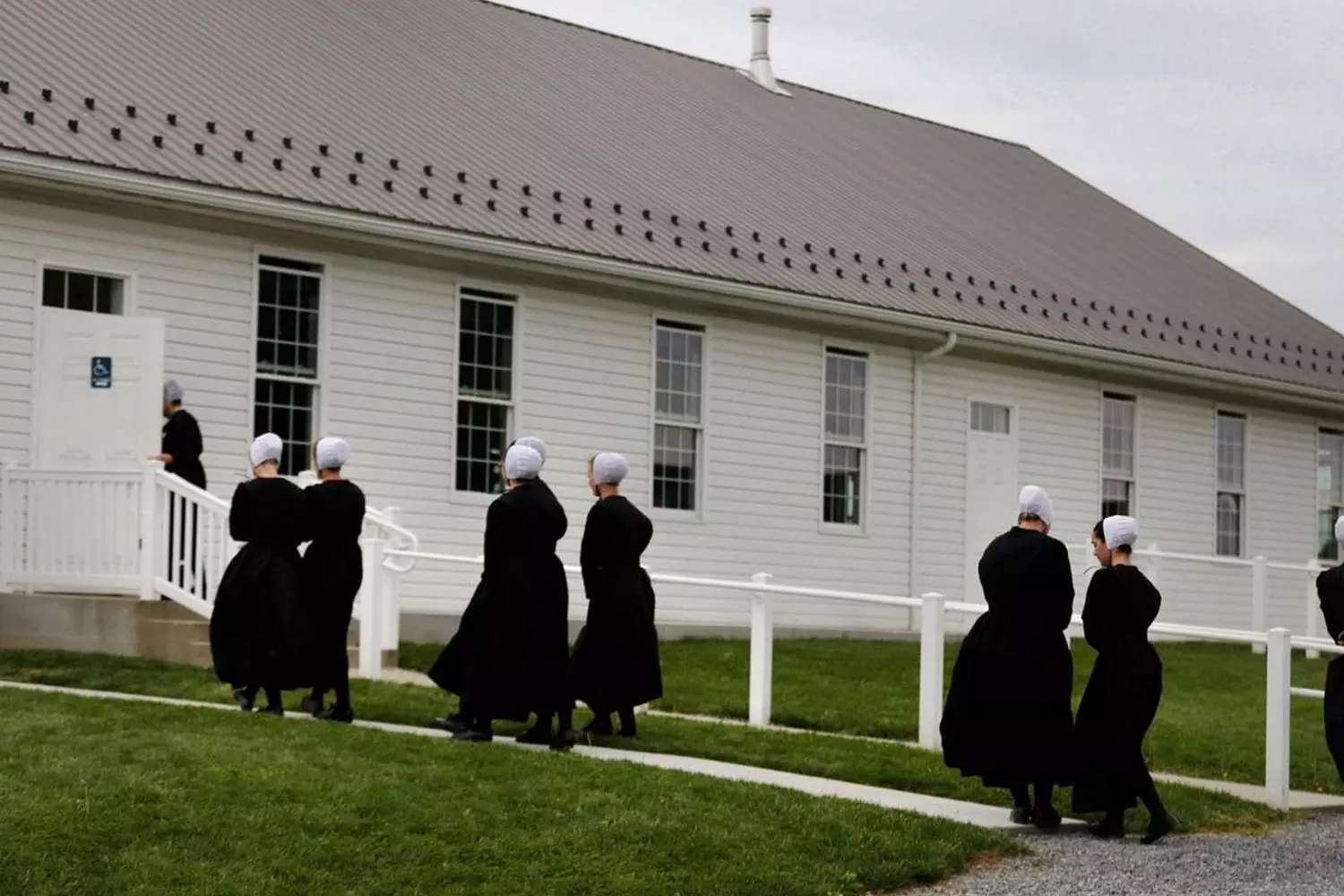 Amish Women’s Sunday Walk: A Journey of Faith and Tradition Amish women in traditional dresses and bonnets walking to church along a dirt road